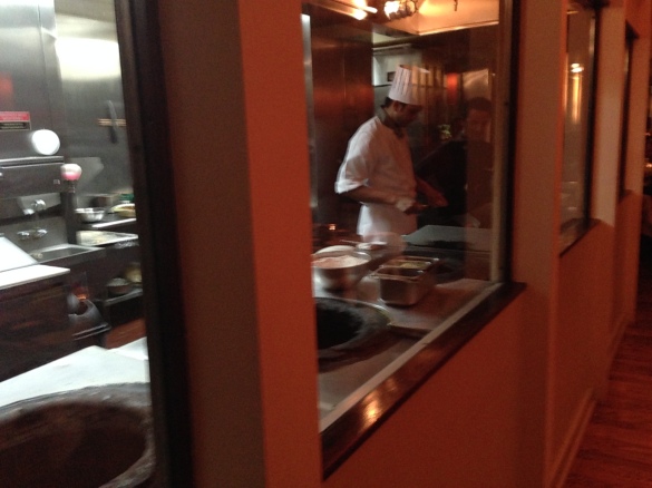 A glimpse into the kitchen, with three large tandoor ovens in action.