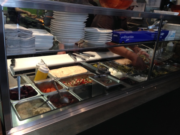 Taim's topping bar, a panoply of sauces and salads.